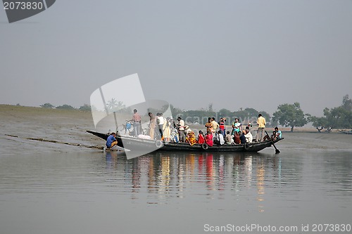 Image of Wooden boat crosses the Ganges River