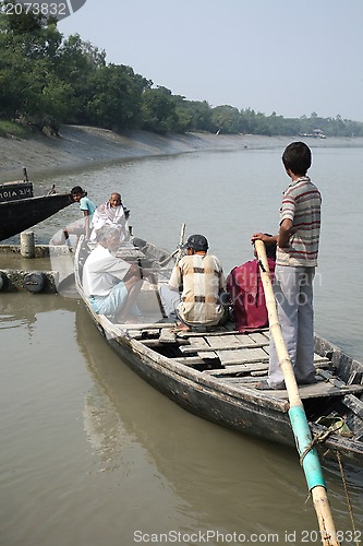 Image of Wooden boat crosses the Ganges River