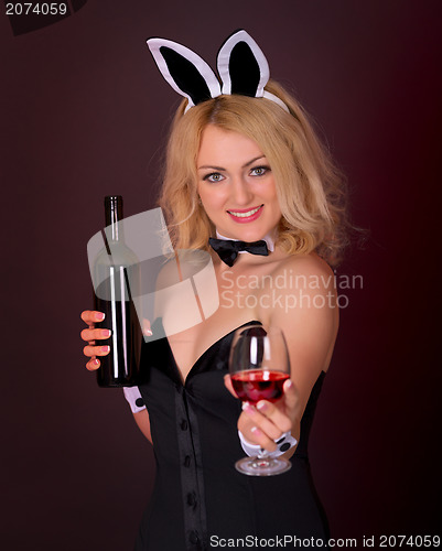 Image of Beautiful young girl dressed as a rabbit with wine