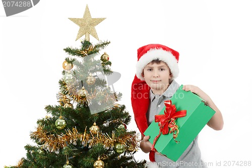 Image of happy boy in santa hat show christmas present