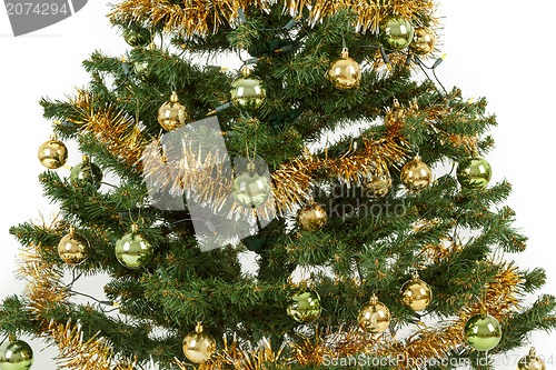 Image of Decorated christmas tree with yellow and green balls 