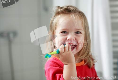 Image of Small girl washing her teeth