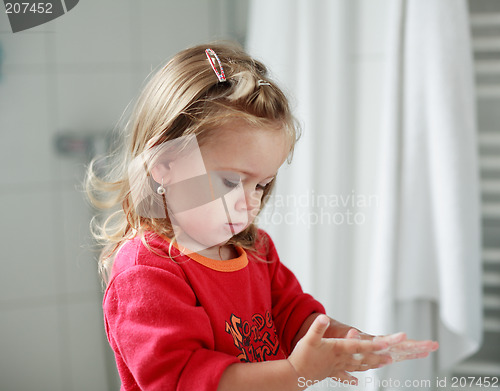 Image of Small girl washing her hands