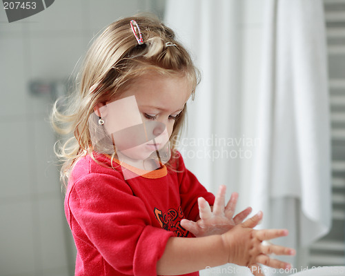 Image of Small girl washing her hands