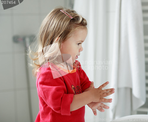 Image of Small girl washing her hands