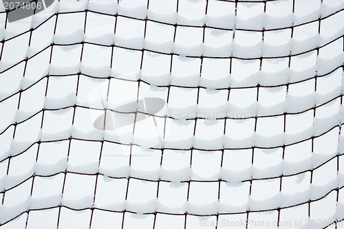 Image of Football goal net, covered with snow