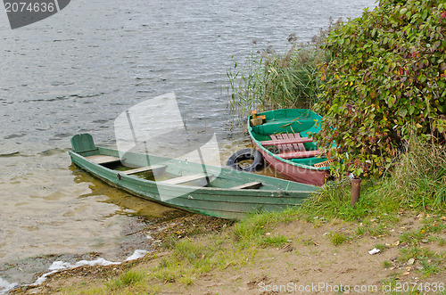 Image of wooden boats full water moored lake shore autumn 