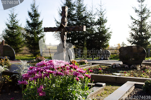 Image of chrysanthemum flower grave cross monument cemetery 