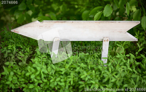 Image of Old wooden arrow indicating the direction