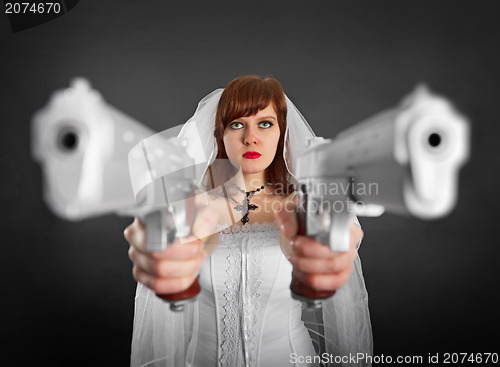 Image of Beautiful bride armed with two pistols