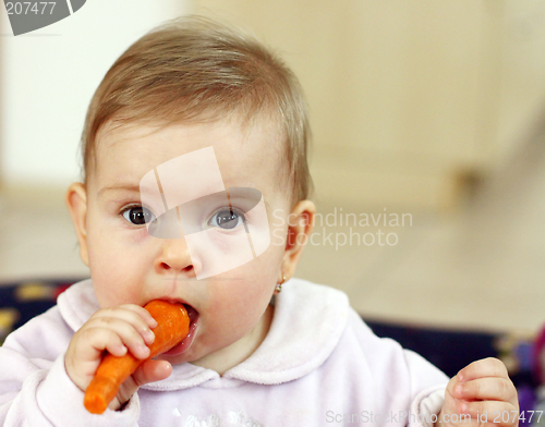 Image of Baby eating carrot