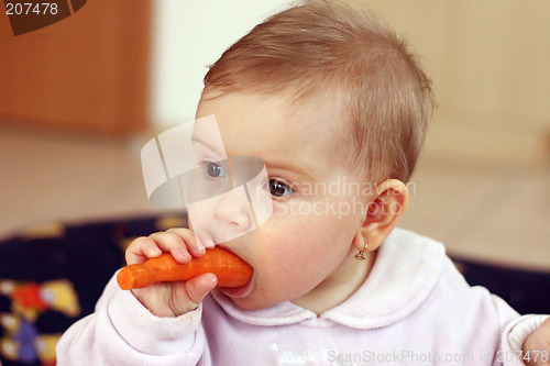 Image of Baby eating carrot