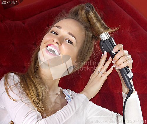 Image of young girl curling her hair