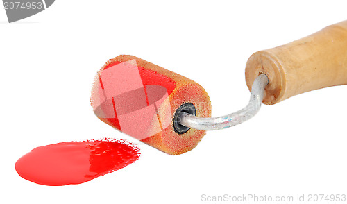 Image of Closeup of roller applying bright red paint