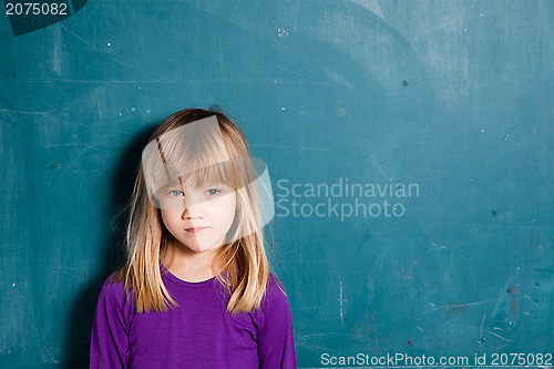 Image of Young girl in front of chalkboard