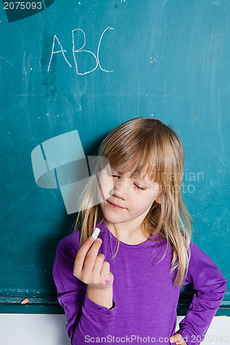 Image of Young girl and chalkboard with letters