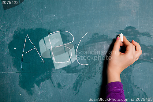 Image of Wiriting letters on chalkboard