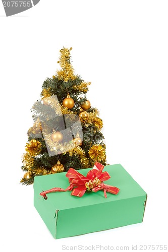 Image of yellow decorated christmas tree  and gift with red ribbon