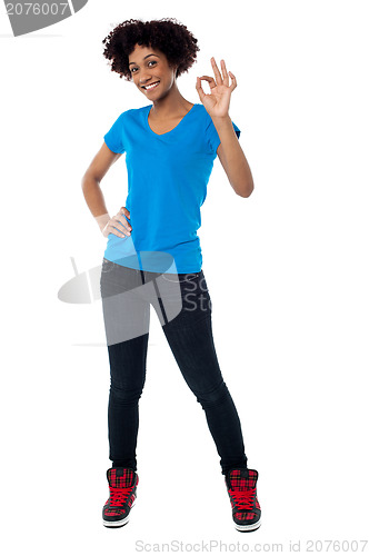 Image of Pretty female model gesturing perfect sign