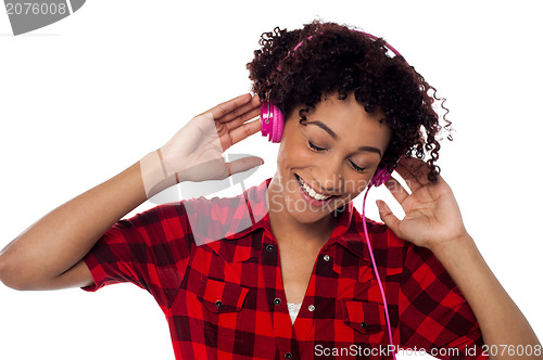 Image of Casual woman lost in pleasant musical world