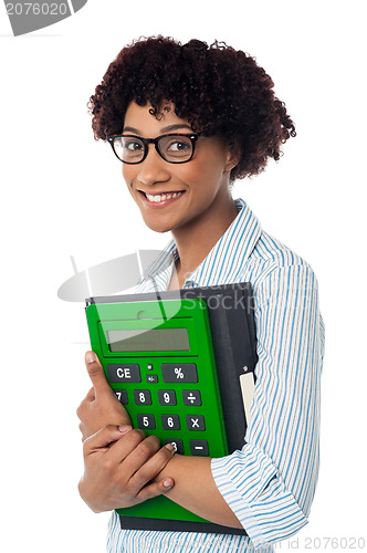 Image of Young businesswoman with calculator and file