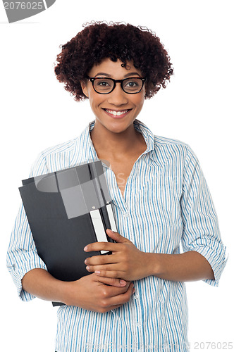 Image of Secretary holding business files, expressing excitement