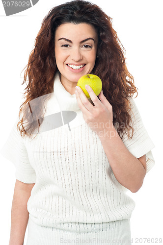 Image of Elegant woman holding fresh green apple