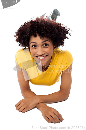 Image of Woman in yellow top relaxing on studio floor