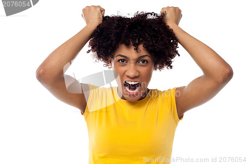 Image of Angry young woman pulling her hair out