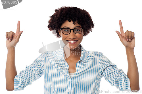 Image of Excited woman pointing upwards