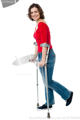 Image of Woman walking with the help of crutches