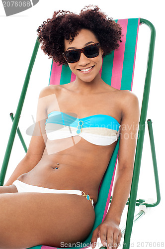 Image of Sexy bikini model seated on a deckchair