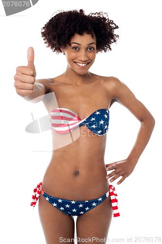 Image of United States flag bikini model gesturing thumbs up