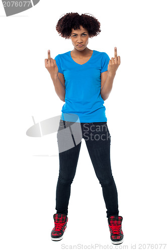 Image of Annoyed young female showing middle finger