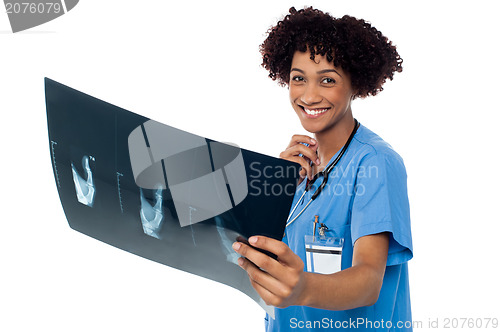 Image of Attractive young medical professional holding x-ray sheet