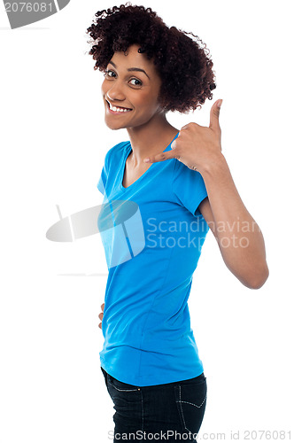 Image of Attractive young model gesturing a mock call