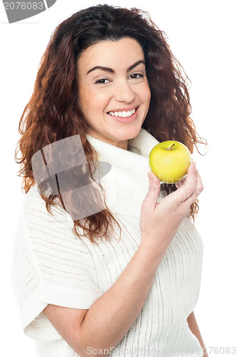 Image of Joyous woman with an apple in hand