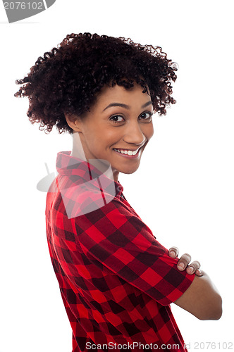 Image of Side profile of slim young smiling woman, arms crossed