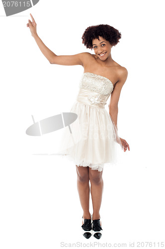 Image of Joyous fashion female model pointing upwards