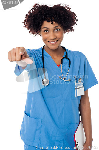 Image of Smiling lady doctor pointing you out