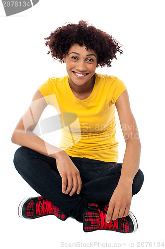 Image of Smiling lady sitting legs crossed on the floor
