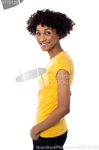 Image of Pretty woman wearing yellow top and jeans