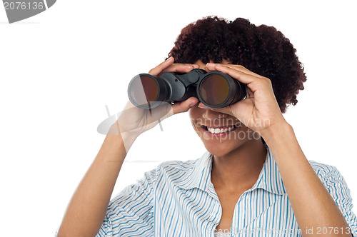 Image of Woman watching through binoculars