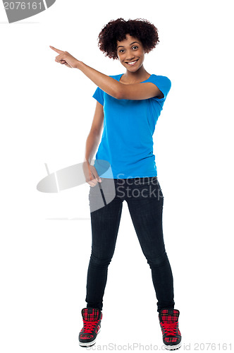 Image of Attractive young woman pointing sideways