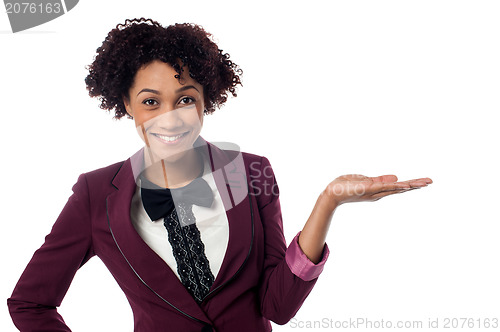 Image of Smiling woman presenting copy space area