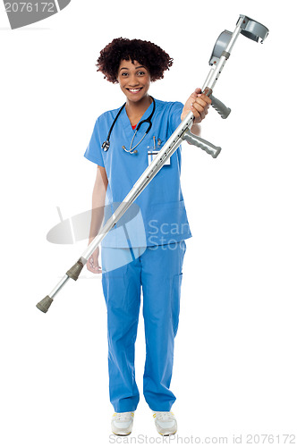 Image of Lady doctor handing over crutches to the patient
