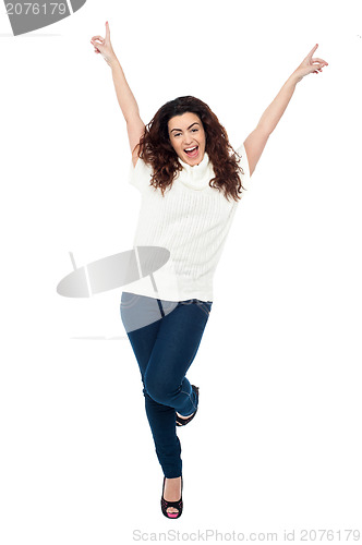 Image of Joyous woman dancing with arms raised