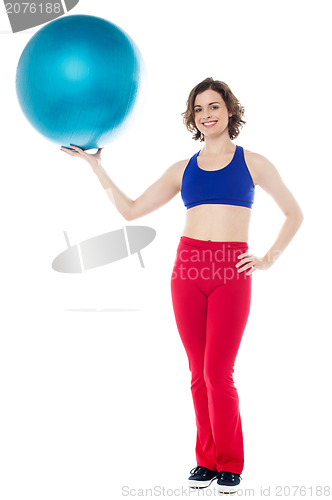 Image of Lady gym instructor holding pilates ball