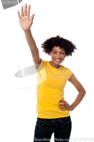 Image of Stylish female waving her hand at you