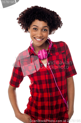 Image of Stylish teenager with headphones around her neck